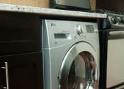 Thumbnail 23 of 25 - a front loading washer and dryer sit next to each other in a kitchen