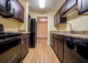 Thumbnail 12 of 28 - Updated Kitchen With Black Appliances at The Plaza at Library Square, Indiana, 46204
