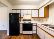 Thumbnail 25 of 35 - Kitchen with white cabinets at Bradford Run in Kokomo, IN