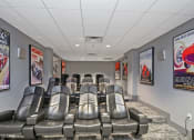 Thumbnail 15 of 21 - a theater room with leather chairs and movie posters on the walls at 3333 Wisconsin, Washington, DC, 20016