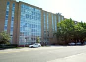 Thumbnail 17 of 21 - a car parked in front of a large brick building at 3333 Wisconsin, Washington, 20016