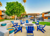 Thumbnail 10 of 36 - Blue Chairs And  Round Firepit at Pacific Trails Luxury Apartment Homes, Covina