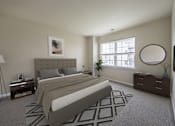 Thumbnail 15 of 35 - Bedroom with cozy bed and lamps at The Apartments at Owings Run, Owings Mills, MD