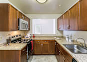 Thumbnail 35 of 35 - Kitchen with cabinets at The Apartments at Owings Run, Maryland, 21117