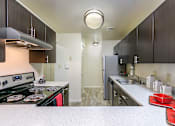 Thumbnail 32 of 35 - Kitchen with cabinets and light at The Apartments at Owings Run, Owings Mills, MD, 21117