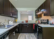 Thumbnail 33 of 35 - Kitchen with cabinets and lights at The Apartments at Owings Run, Owings Mills, MD