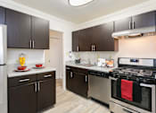 Thumbnail 14 of 39 - Kitchen With White Cabinetry And Black Appliances at Annapolis Roads, Annapolis, MD, 21403