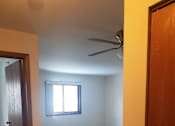 Thumbnail 5 of 15 - A room with a carpeted floor, a ceiling fan, and a window with blinds.