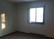 Thumbnail 4 of 15 - A room with a window and a carpeted floor.