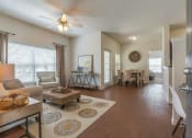 Thumbnail 12 of 44 - Spring TX Apartments - Edgewater at Klein - Spacious Living Room with Wood-Style Flooring and a Dining Nook
