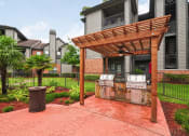 Thumbnail 11 of 44 - Spring TX Apartments for Rent - Edgewater at Klein - Outdoor Grill Area Shaded by a Pergola