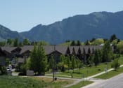 Thumbnail 4 of 15 - Lush Green Courtyard Wit Walking Paths at Saddleview Apartments, Bozeman, MT