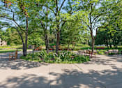 Thumbnail 19 of 21 - A park with benches and trees at Humboldt Senior 55+ Apartments, Saint Paul, MN