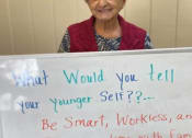 Thumbnail 7 of 36 - Senior Resident Holding A Sign Board at Savannah Court of Camilla, Camilla, GA, 31730