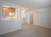 Thumbnail 7 of 12 - kitchen with white appliances and wooden cabinets.