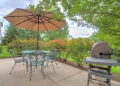 Thumbnail 9 of 15 - barbecue area at Creekside at Taskers Chance in Frederick, MD with dining table and chairs and barbecue grill