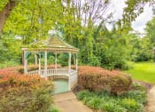 Thumbnail 10 of 15 - gazebo at Creekside at Taskers Chance in Frederick, MD with bushes, shrubs and grass surrounding gazebo and walkway
