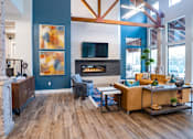 Thumbnail 25 of 48 - Contemporary living room with exposed beams and fireplace at Nalle Woods of Westlake Apartments, Texas, 78746