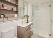 Thumbnail 13 of 33 - a bathroom with a shower and a sink and a toilet