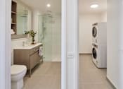 Thumbnail 14 of 33 - a bathroom with a washer and a dryer in it