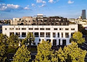 Thumbnail 1 of 33 - an aerial view of a white building with trees in front of it