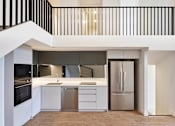 Thumbnail 33 of 33 - a kitchen with white cabinets and a stainless steel refrigerator