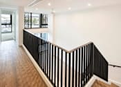Thumbnail 32 of 33 - a staircase with a black and white railing and a glass door