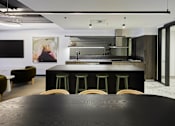 Thumbnail 5 of 33 - a large black kitchen with a table and chairs