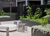 Thumbnail 31 of 33 - an outdoor seating area with tables and plants