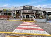 Thumbnail 6 of 20 - The entrance to the Wynnum Plaza shopping center.