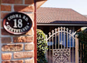 Thumbnail 1 of 12 - A sign on a brick wall that says