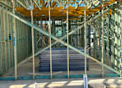 Thumbnail 3 of 9 - A construction site with wooden beams and concrete slabs.