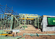 Thumbnail 4 of 9 - A construction site with a large metal framework and scaffolding.
