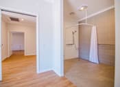 Thumbnail 8 of 12 - A bathroom with a walk-in shower and a towel rack.