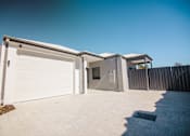 Thumbnail 7 of 12 - A white garage door is open.