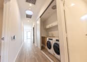 Thumbnail 5 of 11 - A laundry room with a washer and dryer in it.