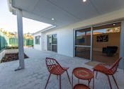 Thumbnail 9 of 11 - A patio with a table and chairs.