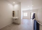 Thumbnail 4 of 15 - A bathroom with a sink, mirror, and tiled floor.