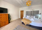 Thumbnail 5 of 12 - a bedroom with a bed and a dresser and a tv