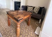Thumbnail 6 of 12 - a living room with a coffee table and a couch