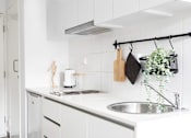 Thumbnail 8 of 11 - a white kitchen with a sink and white cabinets