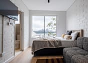 Thumbnail 1 of 9 - a bedroom with a bed and a window and a couch