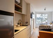 Thumbnail 9 of 9 - a small apartment with a bed and a kitchen