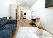 Thumbnail 4 of 20 - a living room with a couch and a coffee table