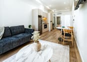 Thumbnail 8 of 20 - a living room with a couch and a table