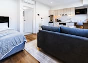 Thumbnail 3 of 20 - a living room with a couch and a bed