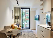 Thumbnail 1 of 11 - a kitchen and living room with a door to a balcony