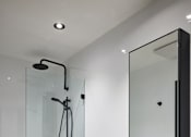 Thumbnail 10 of 11 - a white bathroom with a shower sink and toilet
