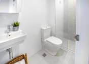 Thumbnail 8 of 13 - a white bathroom with a toilet and a sink