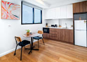 Thumbnail 4 of 13 - a kitchen and dining area with a table and chairs